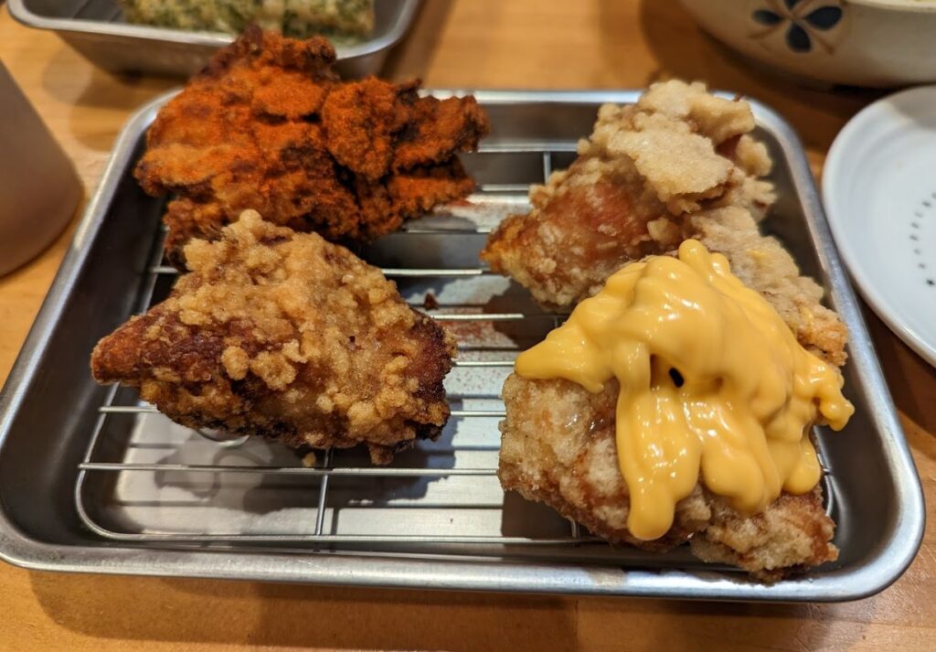 4 pieces of fried chicken with different coatings